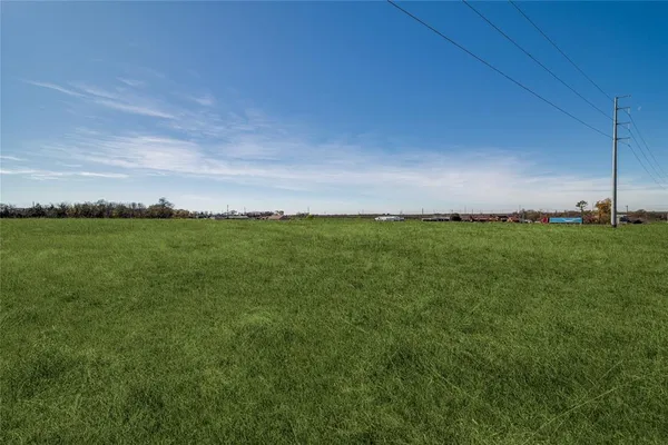 a view of a field with an ocean