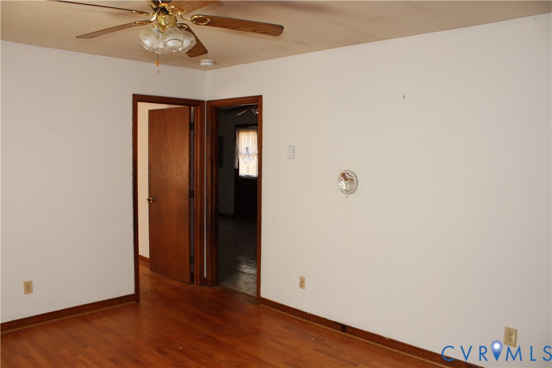 7421 Adkins Road Charles City, VA 23030 - Photo 2 of 14 an empty room with wooden floor closet and fan