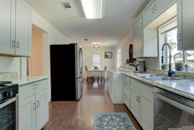 a kitchen with a refrigerator sink and microwave