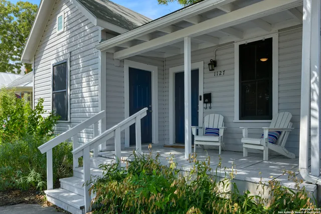 a view of two chairs in the balcony