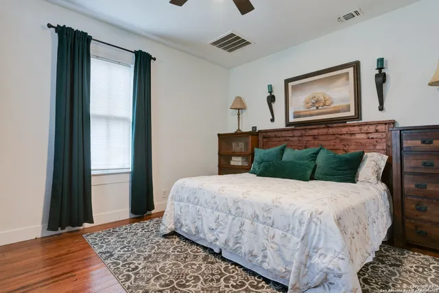 a bedroom with a large bed and a window