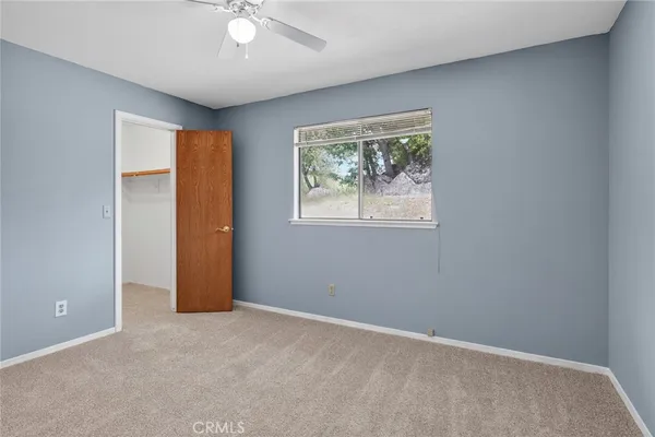 an empty room with windows and closet
