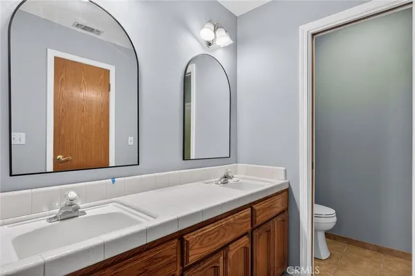 a bathroom with 2 sink and a mirror