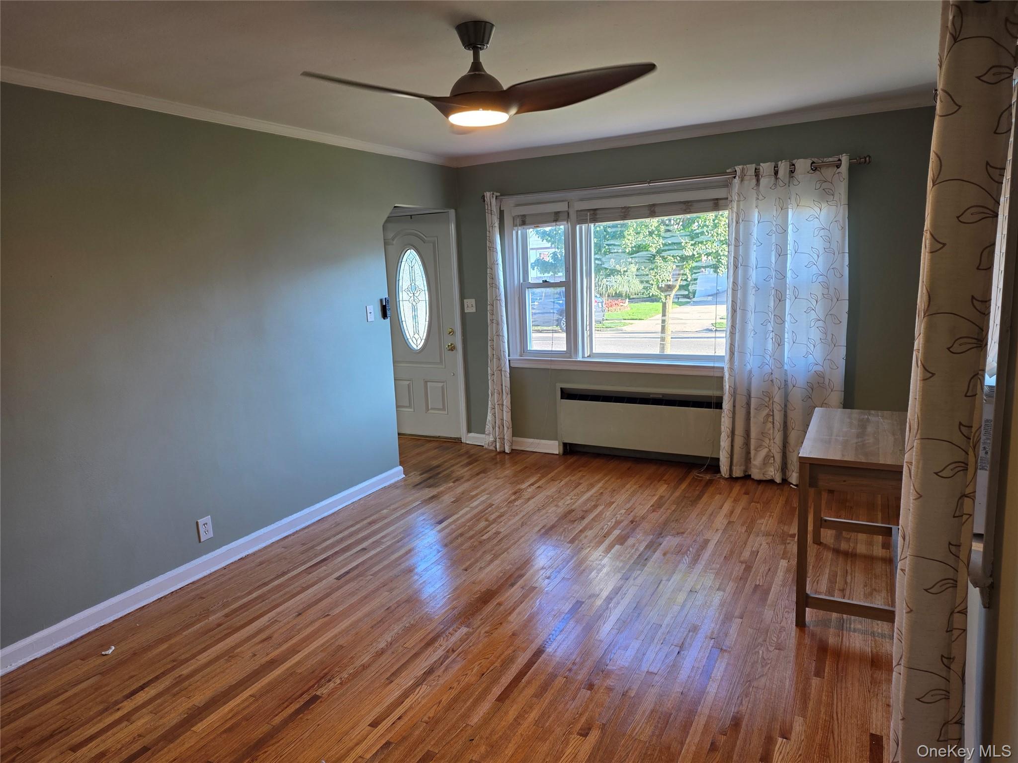 220 Raff Avenue Mineola, NY 11501 - Photo 6 of 22 Entryway featuring ornamental molding, hardwood / wood-style floors, and a ceiling fan