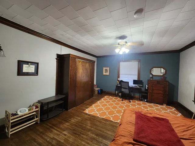 a bedroom with a bed dresser and a window