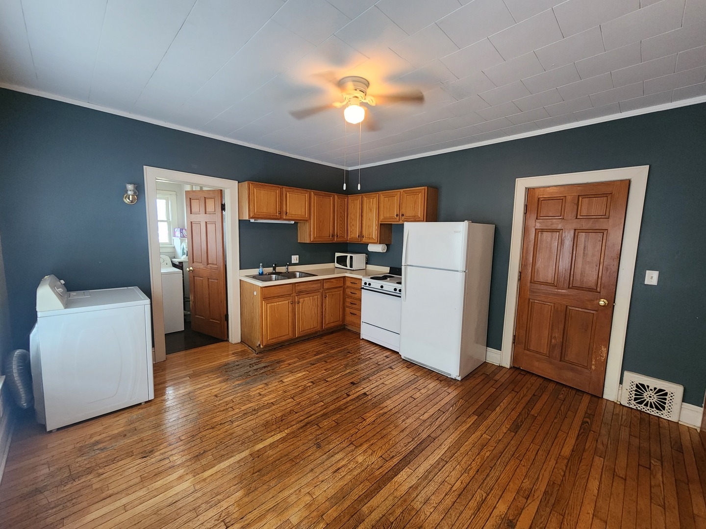 1125 Paul Street Ottawa, IL 61350 - Photo 15 of 29 a kitchen with a refrigerator a stove top oven a counter space and wooden floor