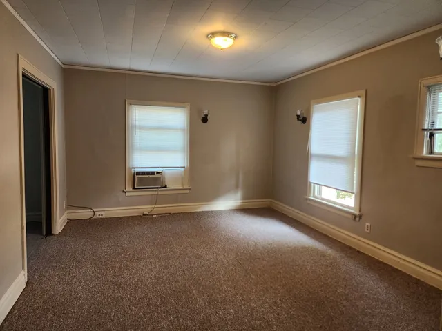 an empty room with a empty space and windows