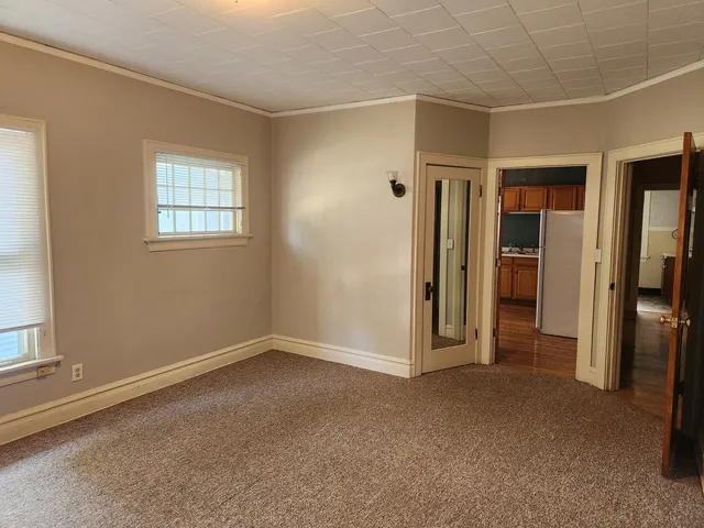 an empty room with closet and a window