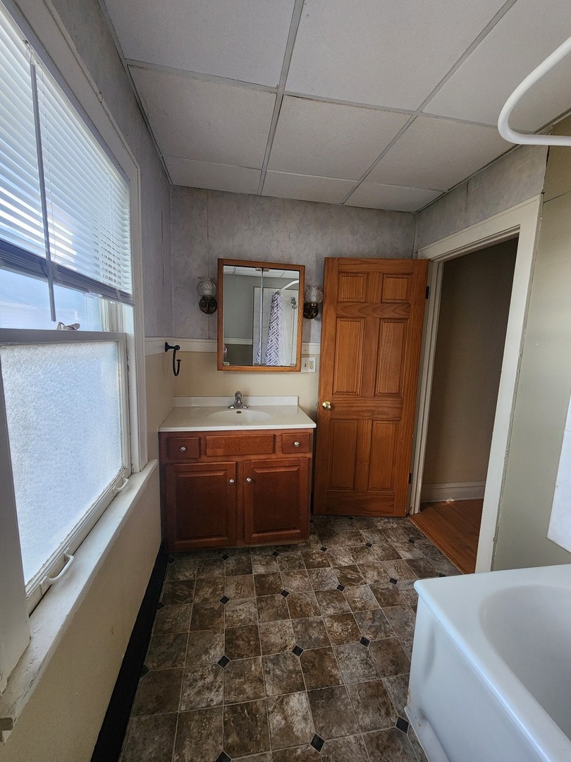 1125 Paul Street Ottawa, IL 61350 - Photo 23 of 29 a bathroom with a tub sink and mirror