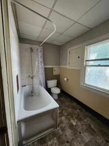 a bathroom with a sink a toilet and tub