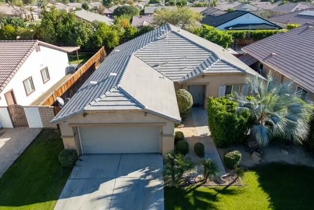 a view of house with backyard and garden