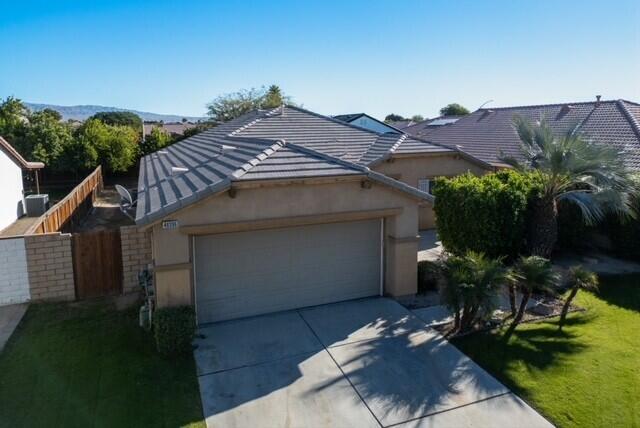 48396 Agua Caliente Street Coachella, CA 92236 - Photo 2 of 14 front view of a house with a yard