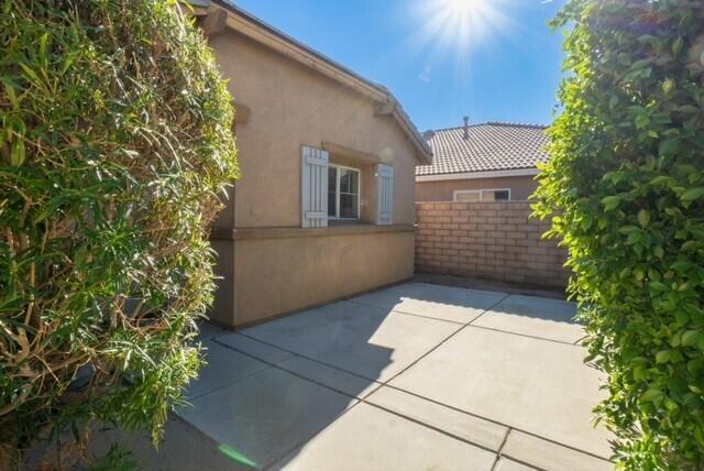 48396 Agua Caliente Street Coachella, CA 92236 - Photo 4 of 14 a pathway of a house with potted plants