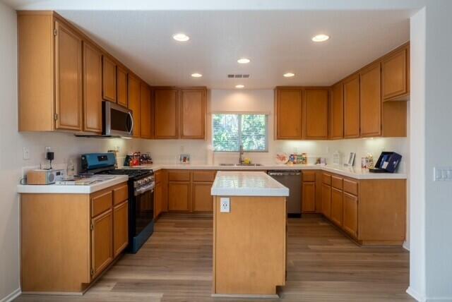 48396 Agua Caliente Street Coachella, CA 92236 - Photo 5 of 14 a kitchen with kitchen island granite countertop wooden cabinets a sink and a stove