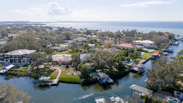 an aerial view of a houses with city view