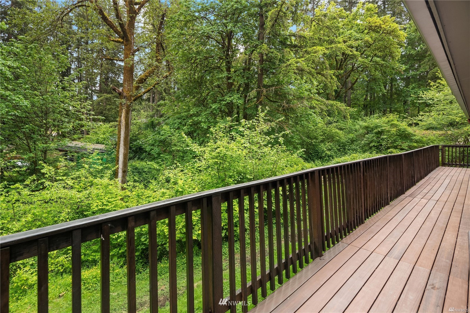 17853 Southeast 146th Street Renton, WA 98059 - Photo 25 of 26 a balcony with wooden floor and trees in the back