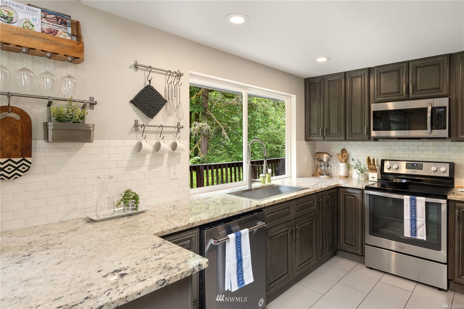 17853 Southeast 146th Street Renton, WA 98059 - Photo 3 of 26 a kitchen with stainless steel appliances granite countertop a sink and stove top oven