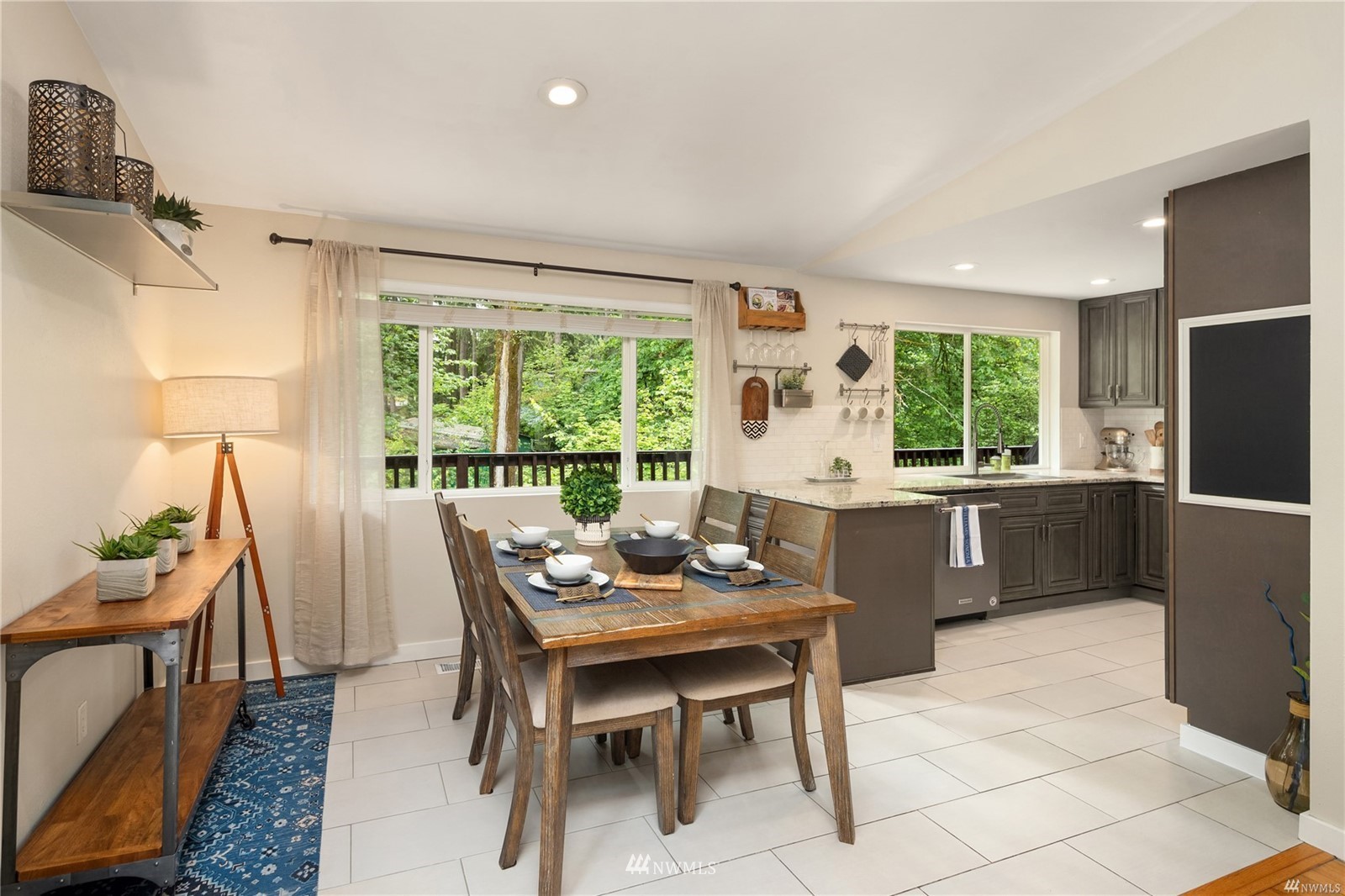 17853 Southeast 146th Street Renton, WA 98059 - Photo 5 of 26 a kitchen with a table chairs and refrigerator