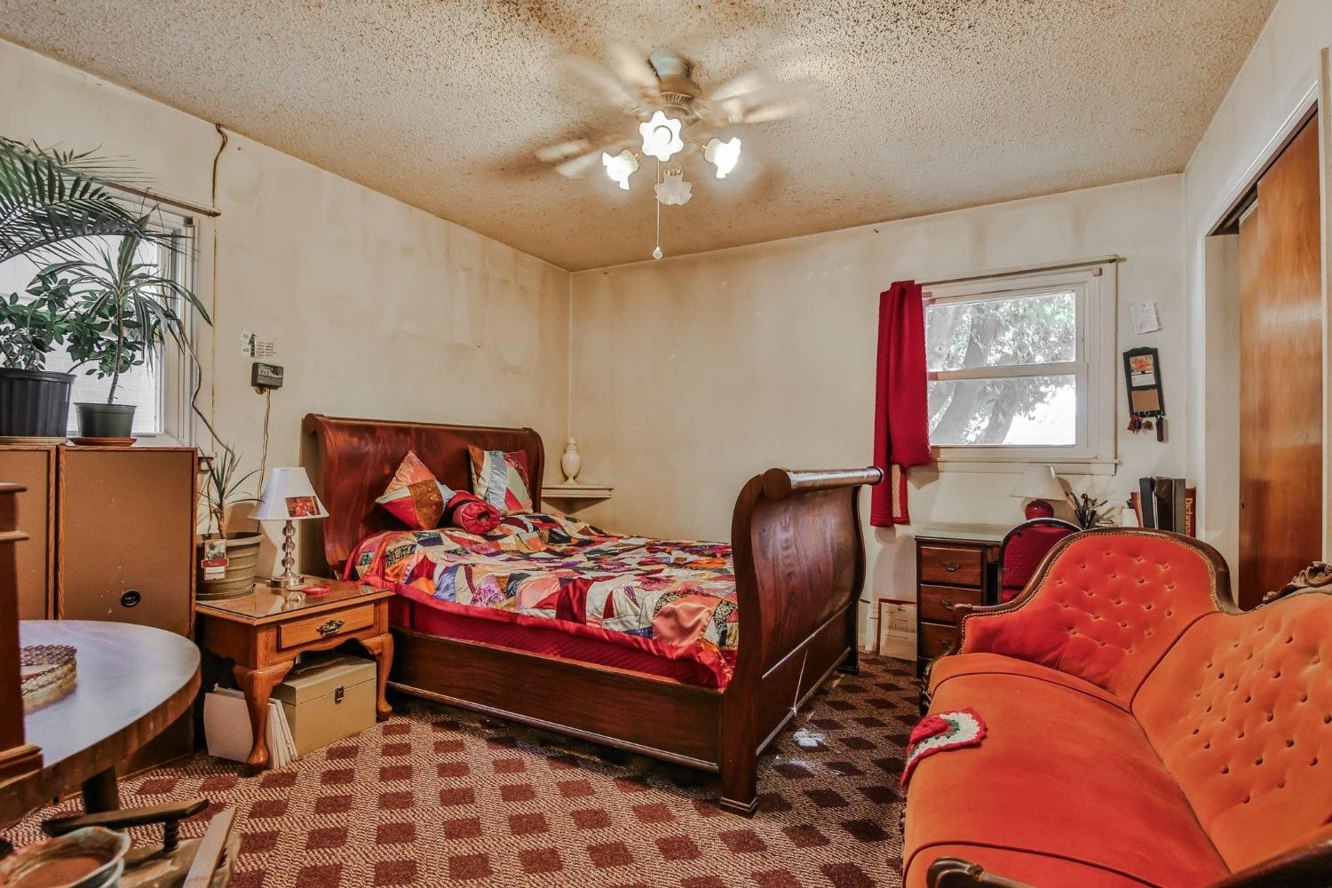 2824 63rd Street Lubbock, TX 79413 - Photo 11 of 24 a bedroom with furniture and a chandelier