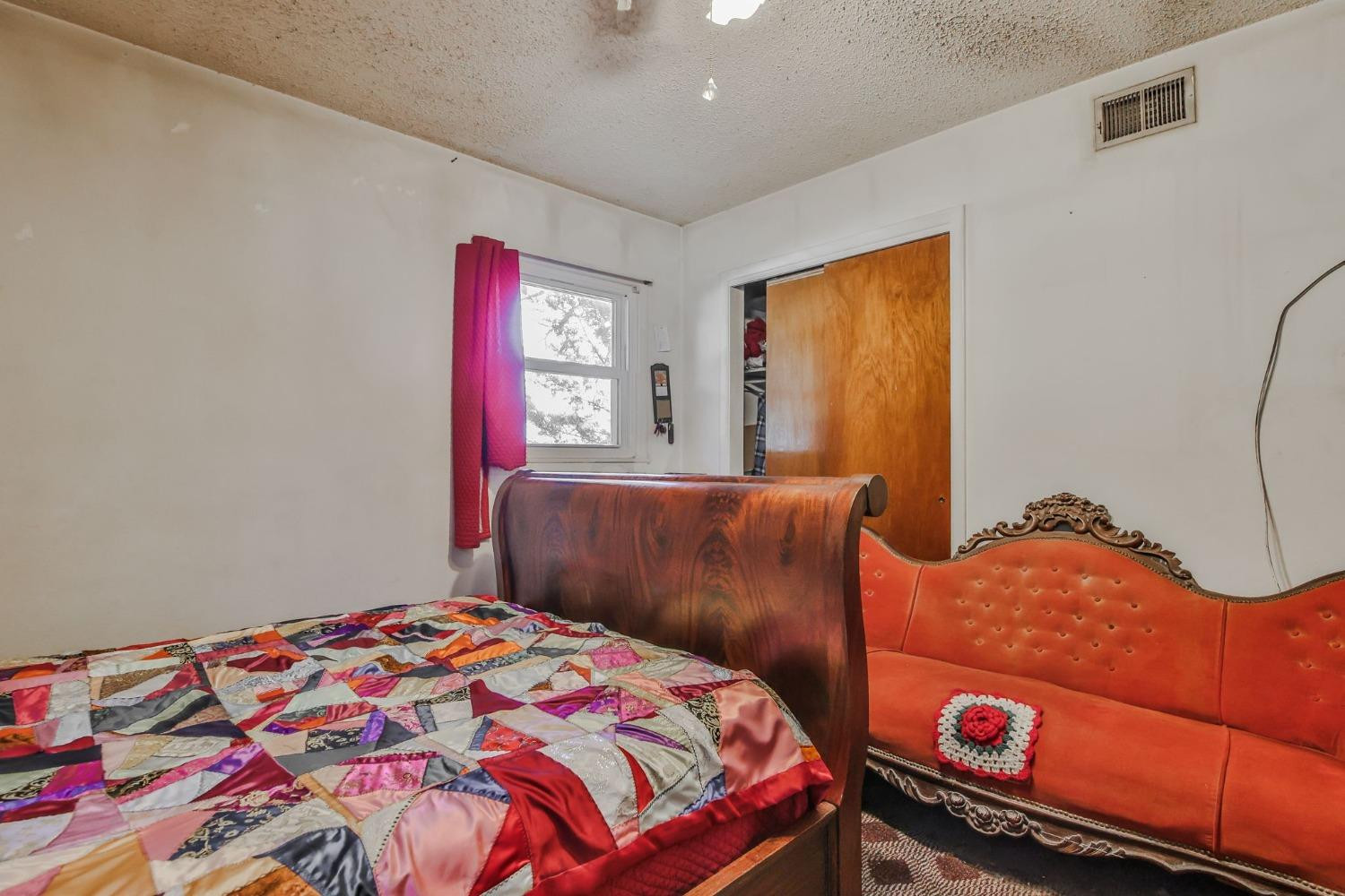 2824 63rd Street Lubbock, TX 79413 - Photo 12 of 24 a bedroom with a bed and a dresser