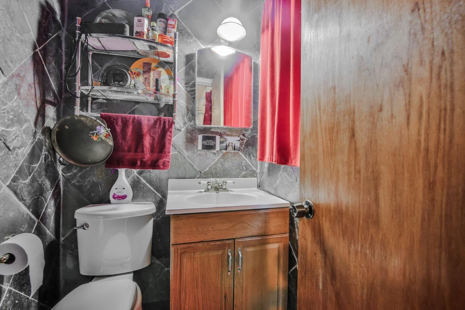 2824 63rd Street Lubbock, TX 79413 - Photo 13 of 24 a bathroom with a sink toilet and shower