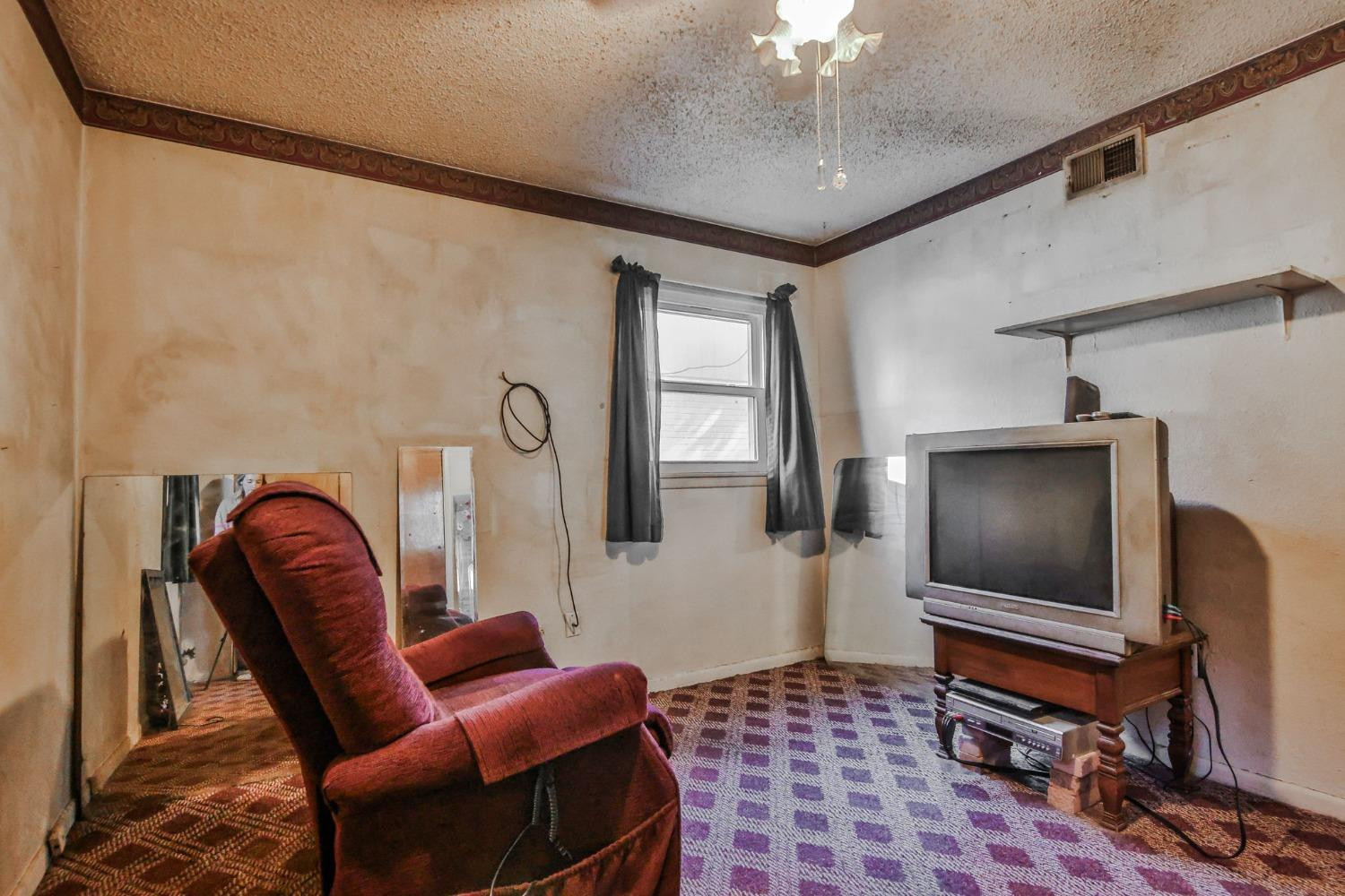 2824 63rd Street Lubbock, TX 79413 - Photo 15 of 24 a living room with furniture and a flat screen tv