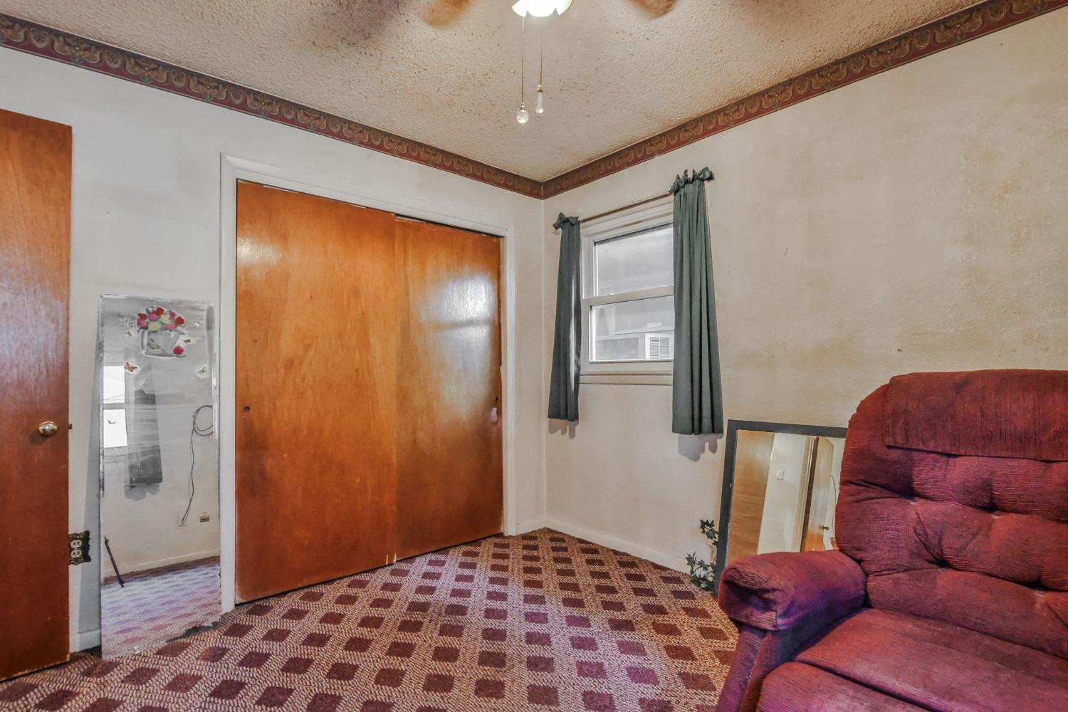 2824 63rd Street Lubbock, TX 79413 - Photo 16 of 24 a bedroom with a bed and a painting on the wall