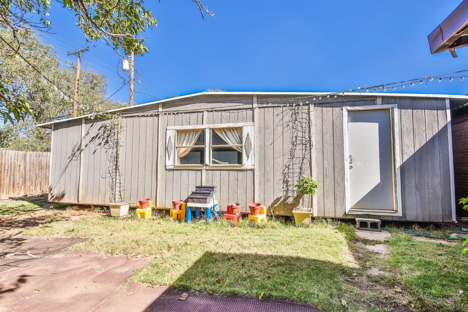 2824 63rd Street Lubbock, TX 79413 - Photo 17 of 24 a front view of a house with a yard