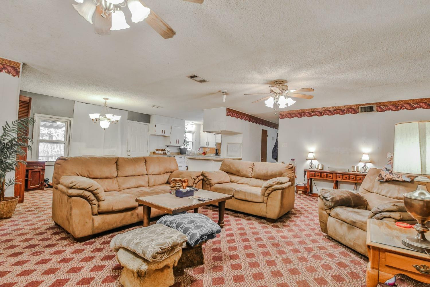 2824 63rd Street Lubbock, TX 79413 - Photo 21 of 24 a living room with furniture and a chandelier