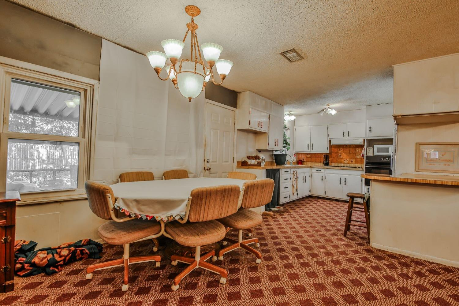 2824 63rd Street Lubbock, TX 79413 - Photo 4 of 24 a living room with couches a dining table and chairs with wooden floor