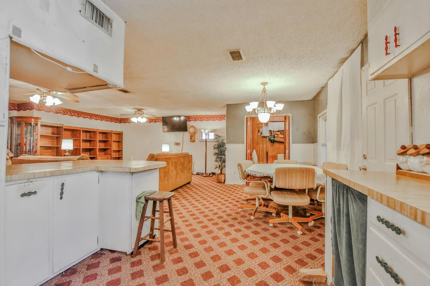 2824 63rd Street Lubbock, TX 79413 - Photo 6 of 24 a living room with stainless steel appliances furniture a rug and a kitchen view