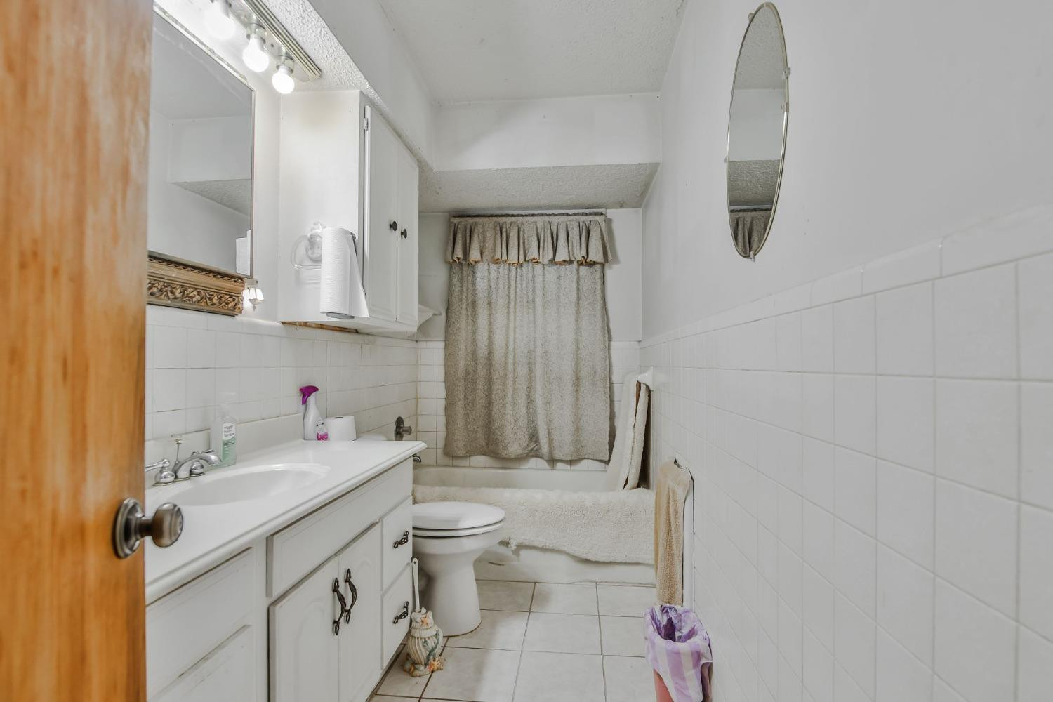 2824 63rd Street Lubbock, TX 79413 - Photo 9 of 24 a bathroom with a sink toilet and shower