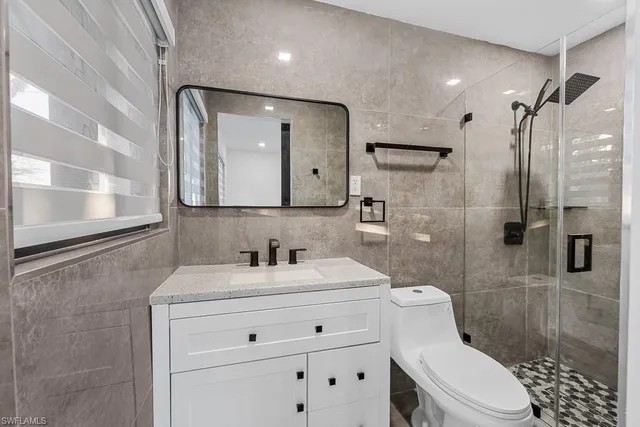 an empty room with windows and glass door