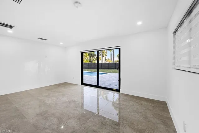 a view of an empty room with kitchen