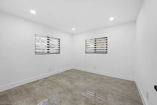 an empty room with windows and closet