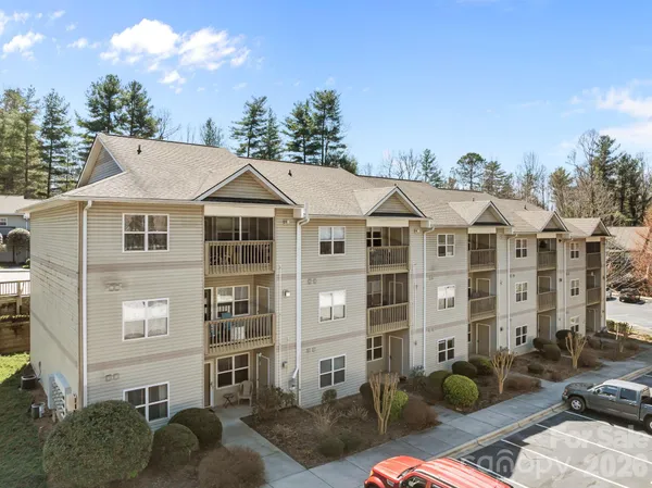 a front view of a residential apartment building with a yard