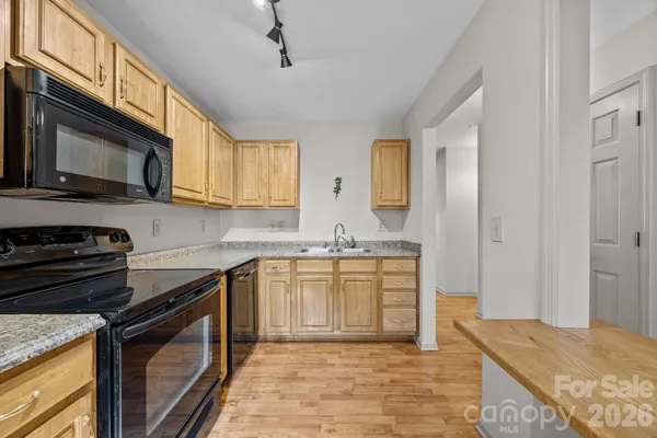 a kitchen with stainless steel appliances granite countertop a sink stove and microwave