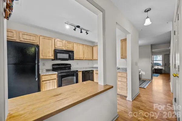 a kitchen with a refrigerator microwave and stove
