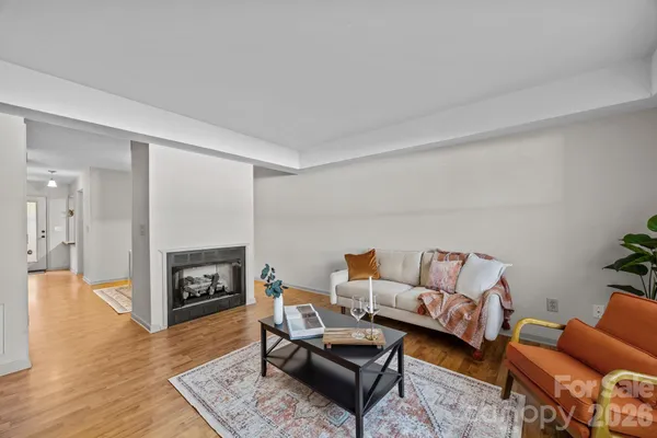 a living room with furniture fireplace and a wooden floor