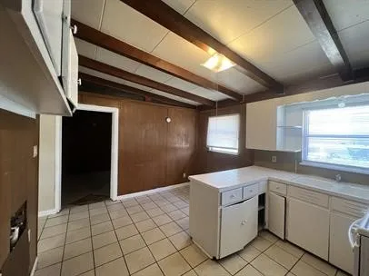 a utility room with cabinets washer and dryer