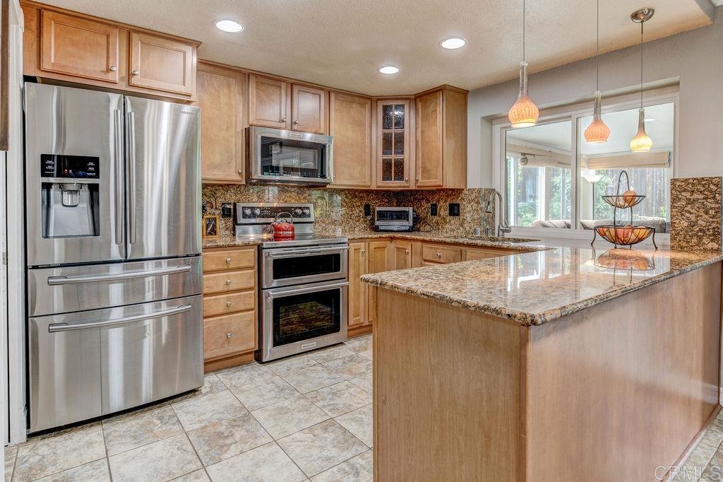 Remodeled kitchen with stainless steel appliances and granite counters