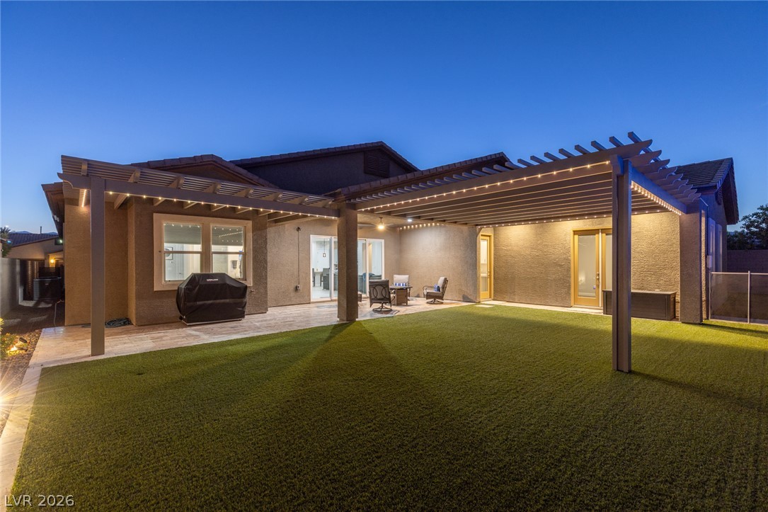 7036 Arabian Ridge Street Las Vegas, NV 89131 - Photo 54 of 64 Step outside to your private backyard oasis featuring a sparkling pool and spa with an automated cover, safety fence, a covered patio with extended
pergolas for additional shade, a dedicated dog run, a freestanding BBQ, and permanent interchangeable lighting system.