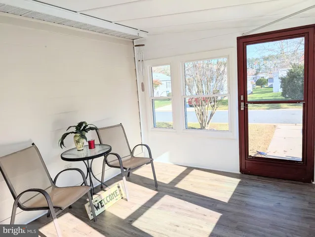 a view of a room with furniture wooden floor and windows