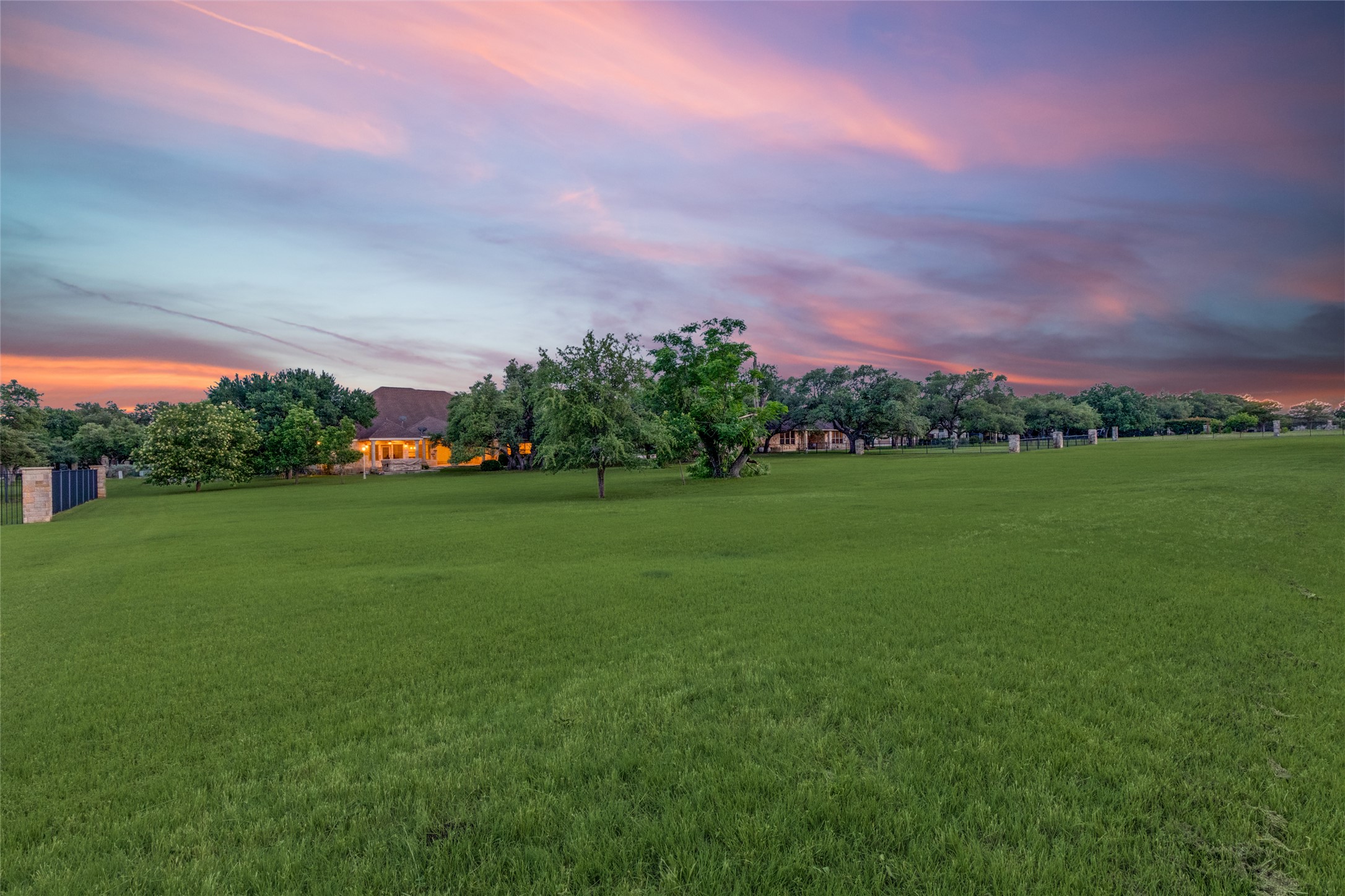 101 Copper Leaf Court Georgetown, TX 78633 - Photo 25 of 31 Expansive green lawn with a distant residence featuring a warm exterior