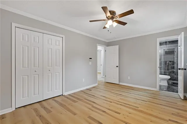 a view of a livingroom with a chandelier fan and wooden floor