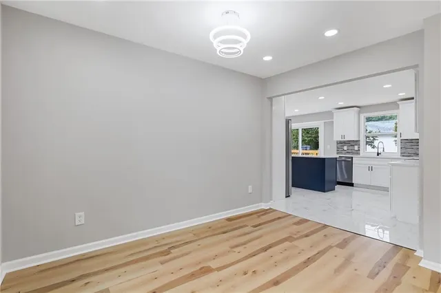 a view of a kitchen with wooden floor and a sink