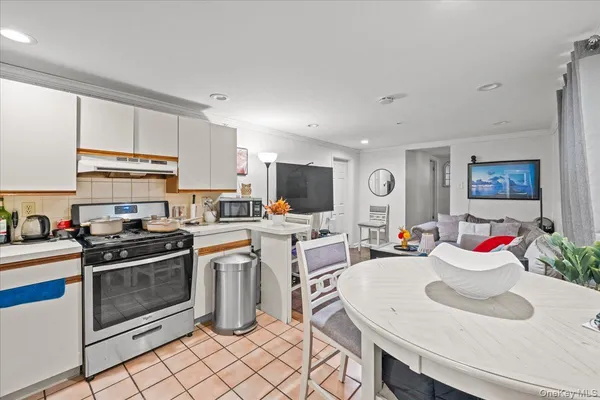 a living room with lots of furniture and kitchen view