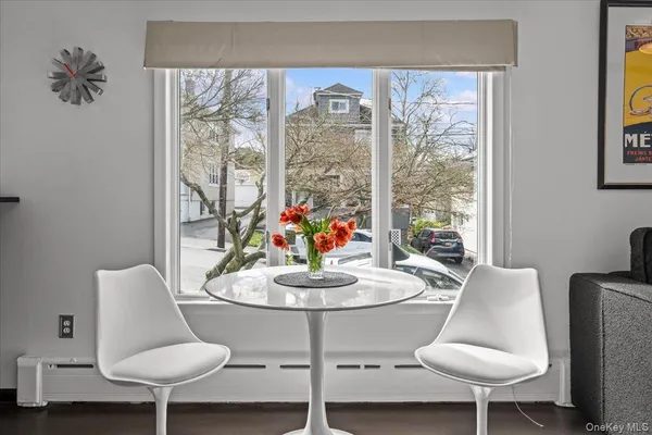 a dining room with furniture and wooden floor