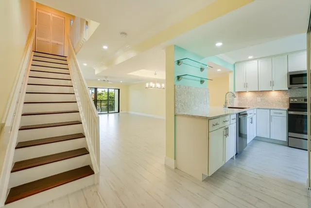 a view of kitchen with sink and wooden floor
