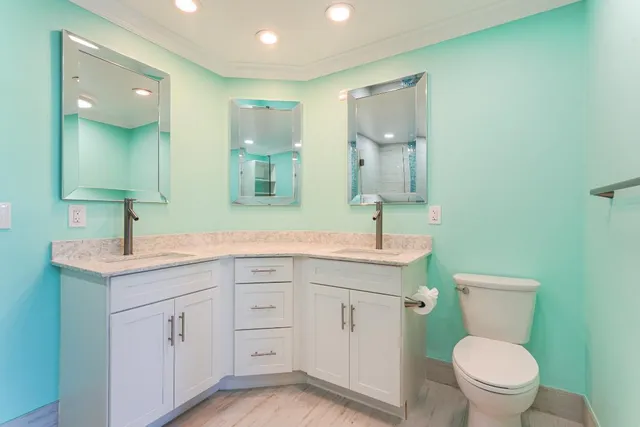 a spacious bathroom with a toilet sink and mirror
